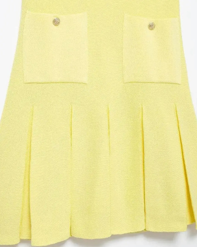 Schwarzes Strickkleid mit Plisseerock, getragen mit Sandalen